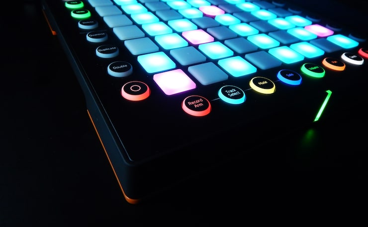 Massive analog mixing console illuminated in the dark