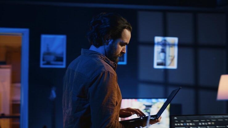 Audio engineer reading an email on a dark monitor
