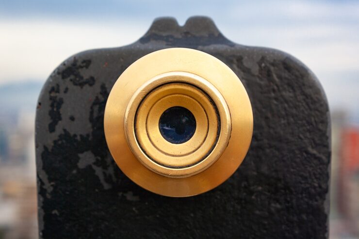 Eye looking through a camera lens