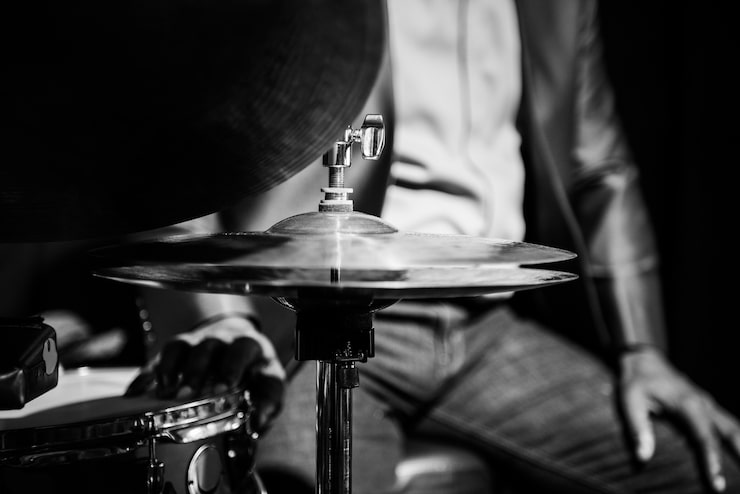 Vintage tube microphone in front of a drum kit