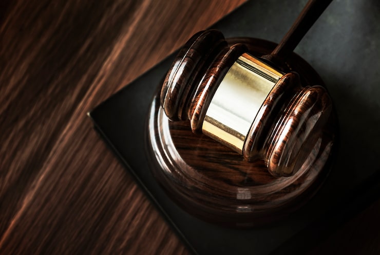 Gavel on a desk in a dark courtroom