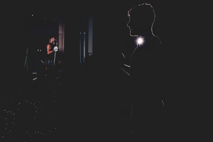 Silhouette of person in front of massive speakers